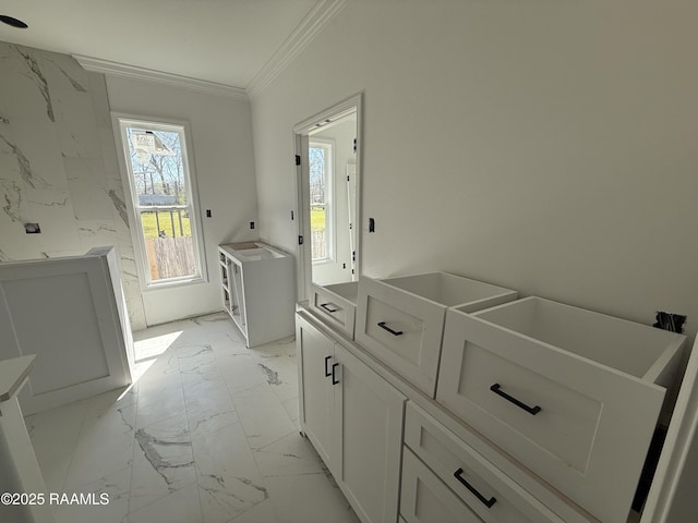 laundry room with marble finish floor and ornamental molding