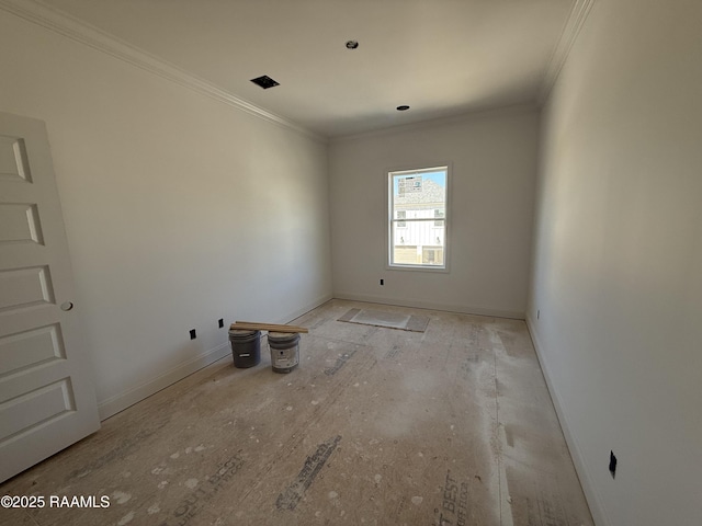 spare room featuring baseboards and crown molding