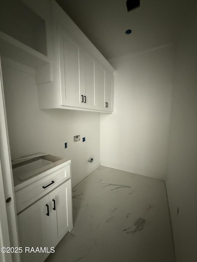 washroom with washer hookup, cabinet space, baseboards, and marble finish floor