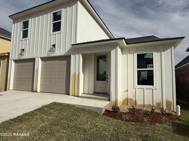 modern farmhouse with a garage, board and batten siding, and driveway