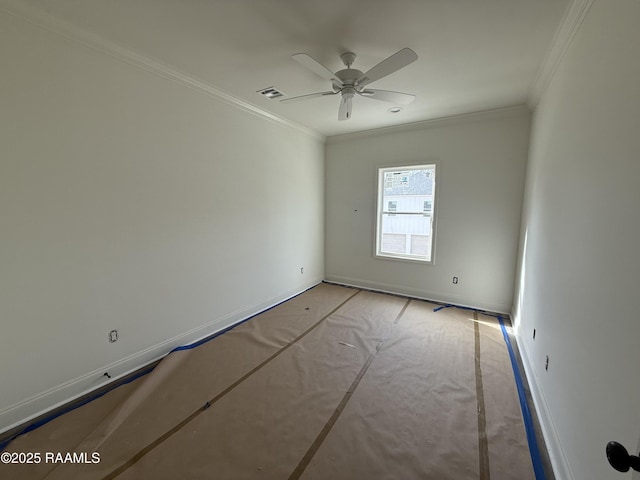 spare room with visible vents, baseboards, crown molding, and ceiling fan