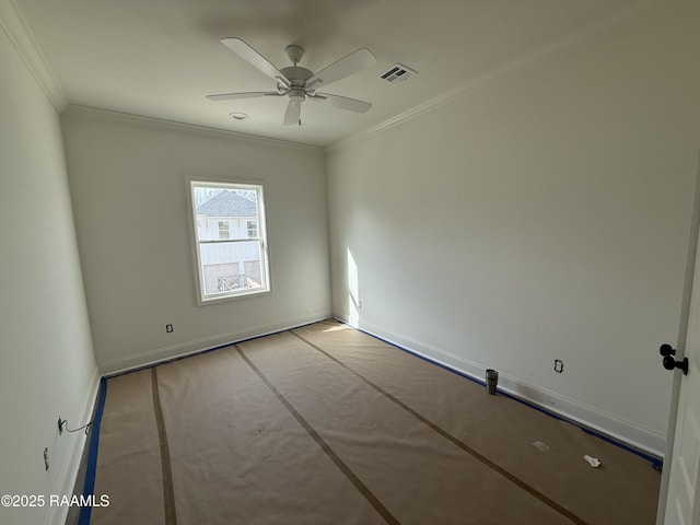 spare room with ceiling fan, visible vents, baseboards, and ornamental molding