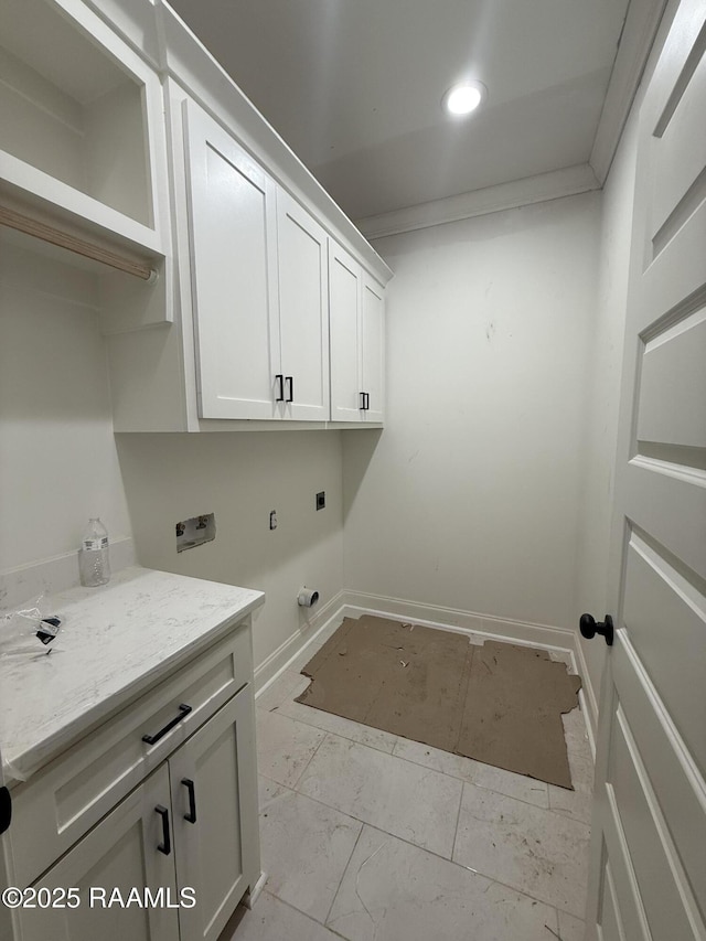 laundry area with hookup for a washing machine, baseboards, cabinet space, electric dryer hookup, and crown molding