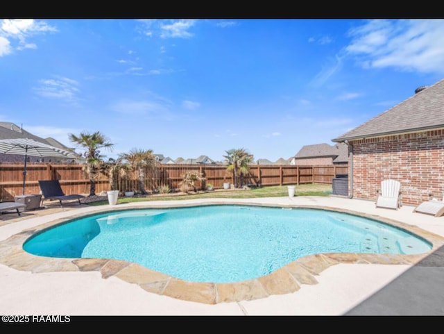 view of swimming pool featuring a fenced in pool, a fenced backyard, and a patio