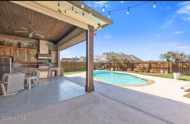 view of pool with a fenced in pool, area for grilling, a patio area, a grill, and a fenced backyard