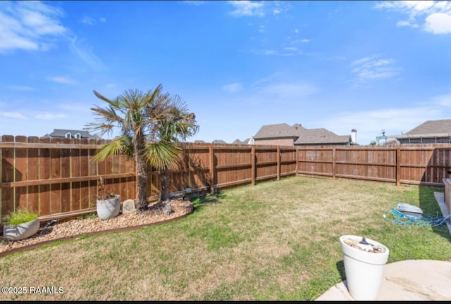 view of yard with a fenced backyard