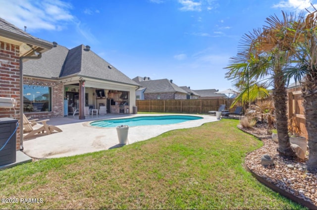 view of swimming pool with a fenced in pool, a fenced backyard, a patio, and a lawn