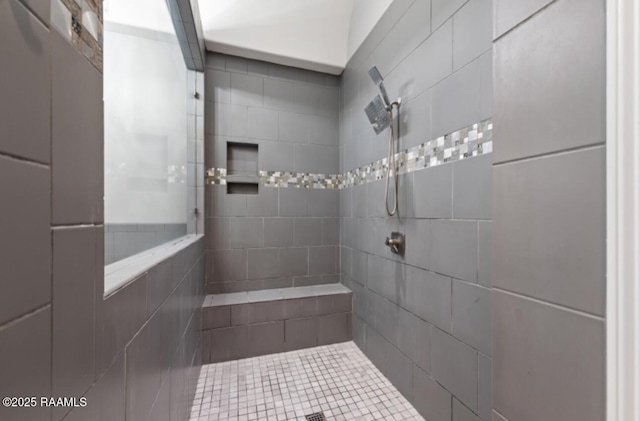 bathroom with tiled shower