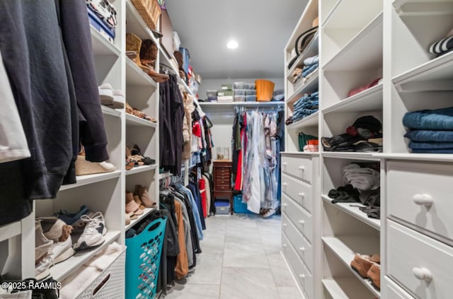 spacious closet with light tile patterned floors