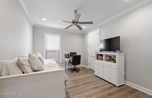 bedroom with baseboards, crown molding, and light wood finished floors