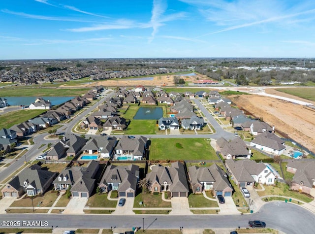 birds eye view of property with a water view and a residential view