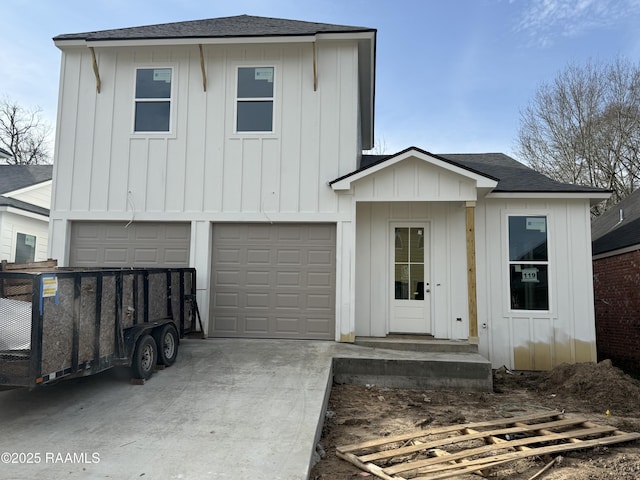 view of front of property featuring an attached garage, board and batten siding, and roof with shingles