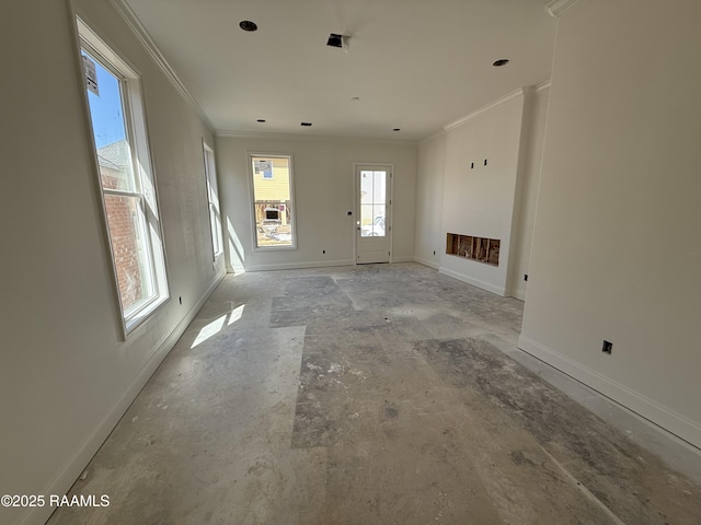 unfurnished living room with baseboards and crown molding