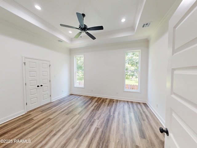 119 Chimney Rock Blvd, Lafayette, LA 70508 - unfurnished bedroom with crown molding, multiple windows, a tray ceiling, light wood-style flooring, and recessed lighting