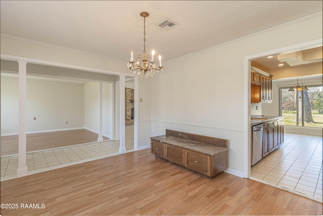 unfurnished dining area featuring light wood-type flooring, visible vents, and ornamental molding