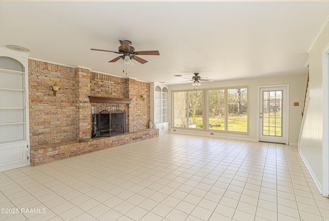 unfurnished living room with light tile patterned floors, built in features, baseboards, ceiling fan, and a brick fireplace