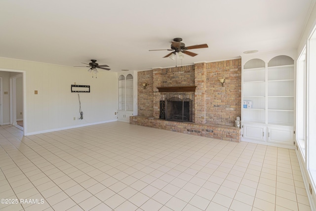 unfurnished living room with light tile patterned floors, baseboards, ceiling fan, built in shelves, and a fireplace