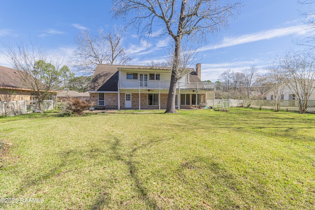 back of property featuring a fenced backyard, a lawn, a chimney, and a balcony