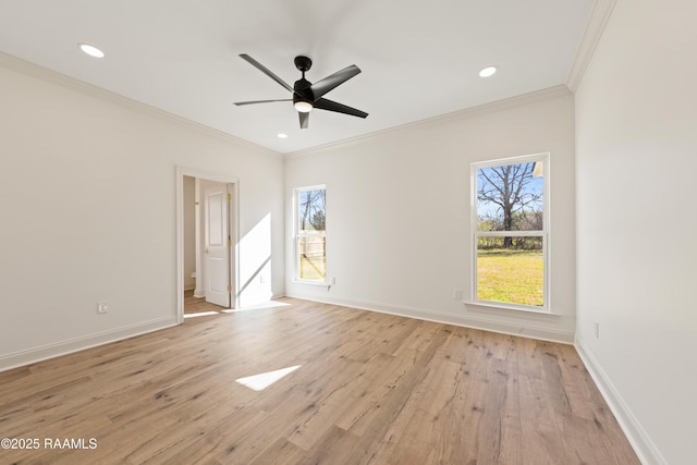 spare room featuring baseboards, light wood-type flooring, and crown molding