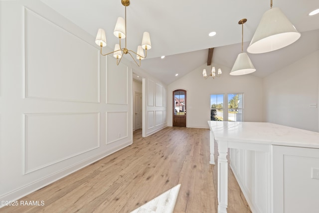 unfurnished dining area featuring light wood-style flooring, vaulted ceiling with beams, a decorative wall, a notable chandelier, and recessed lighting