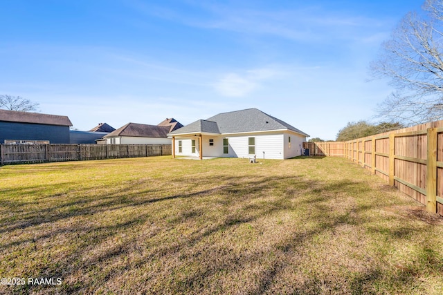 back of property with a yard and a fenced backyard