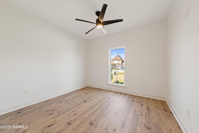 unfurnished room with ceiling fan, hardwood / wood-style floors, and baseboards