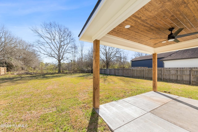 view of yard with a patio area, ceiling fan, and fence