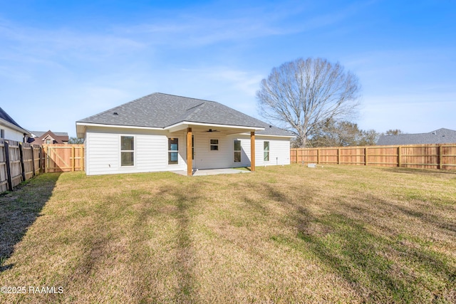 rear view of house featuring ceiling fan, a yard, a patio, and a fenced backyard