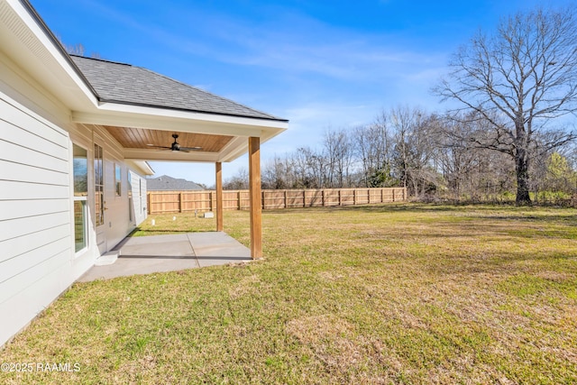 view of yard with fence, a ceiling fan, and a patio