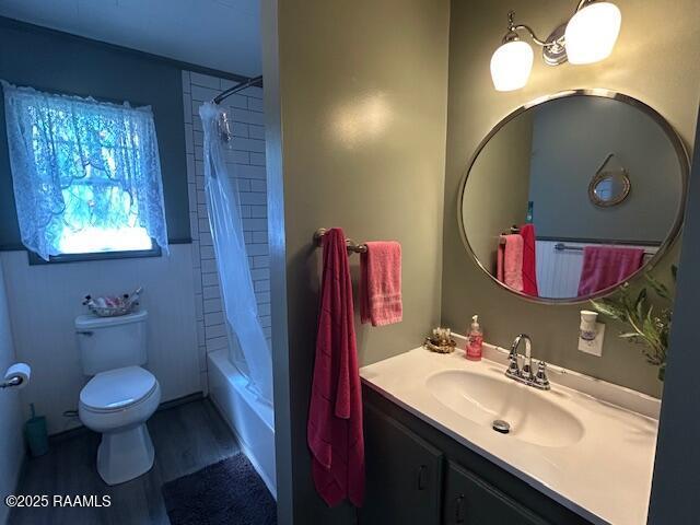 full bathroom featuring shower / bath combination with curtain, wood finished floors, vanity, and toilet