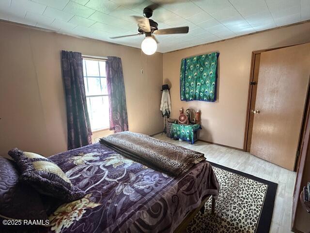 bedroom with ceiling fan and wood finished floors