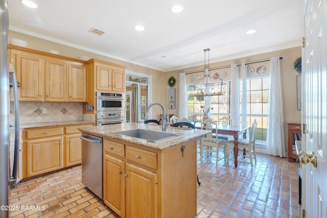 kitchen with visible vents, ornamental molding, stainless steel appliances, and a sink