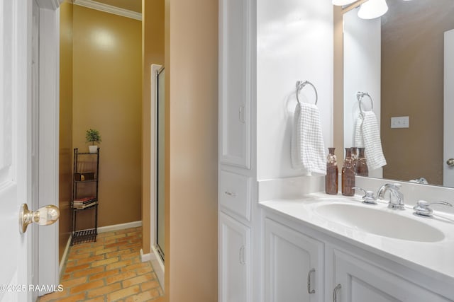 bathroom featuring baseboards, a stall shower, vanity, and brick floor