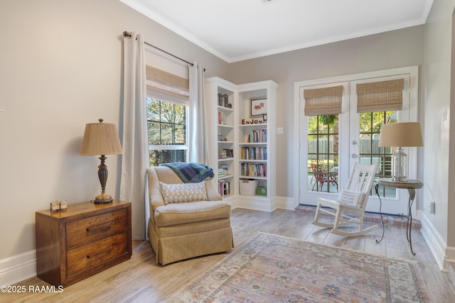 living area with french doors, wood finished floors, and crown molding