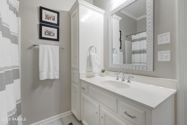 bathroom with vanity, tile patterned floors, baseboards, and ornamental molding