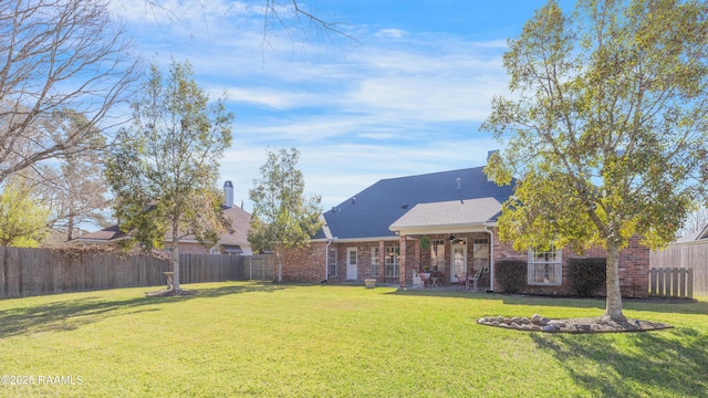 view of yard featuring a fenced backyard, a patio area, and a ceiling fan