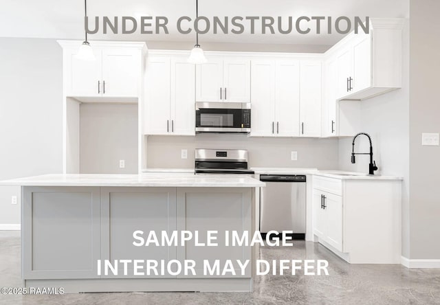 kitchen featuring a sink, stainless steel appliances, a center island, and white cabinetry