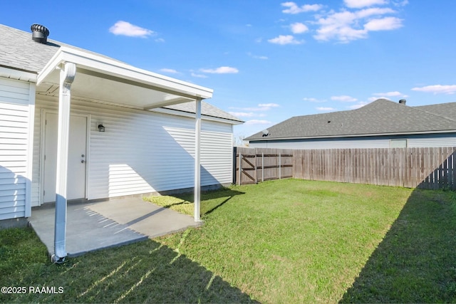 view of yard with fence and a patio