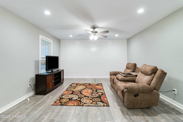 living room featuring recessed lighting, ceiling fan, baseboards, and wood finished floors