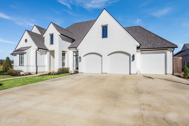 view of front of house featuring concrete driveway and roof with shingles