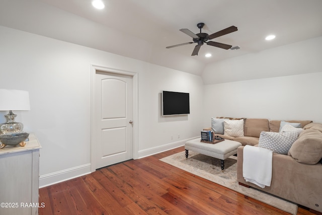 living area with recessed lighting, visible vents, dark wood-type flooring, vaulted ceiling, and baseboards