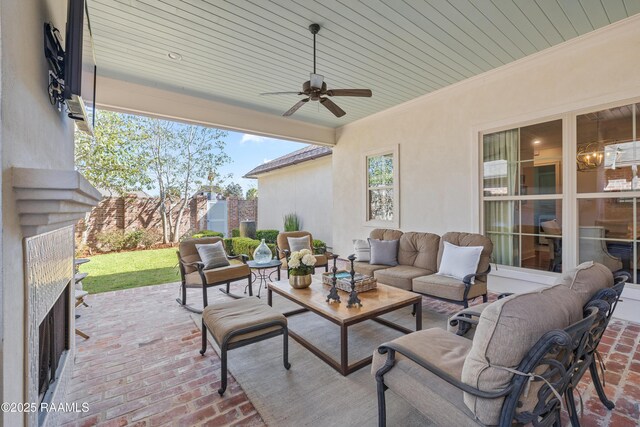 view of patio / terrace featuring a ceiling fan, outdoor lounge area, and fence