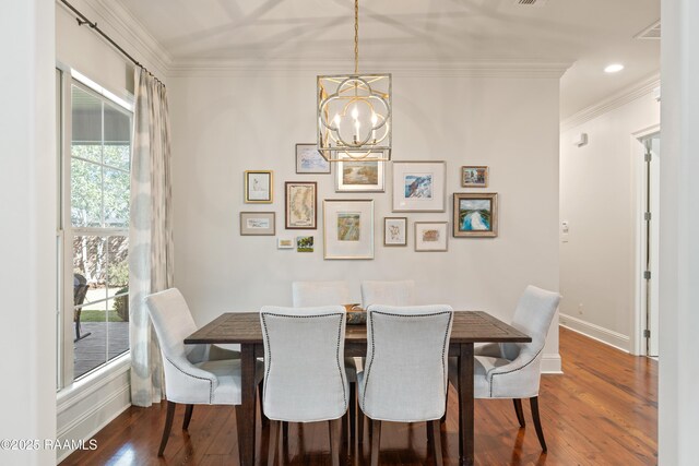 dining area with ornamental molding, dark wood-style flooring, a chandelier, and baseboards