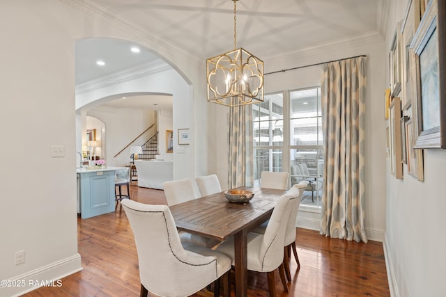 dining space with recessed lighting, crown molding, baseboards, and wood finished floors