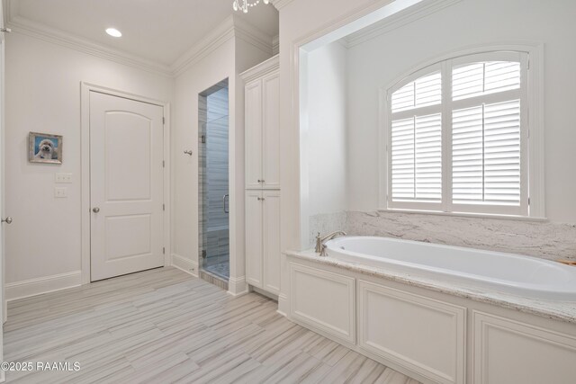 bathroom featuring a garden tub, wood finished floors, baseboards, ornamental molding, and a shower stall