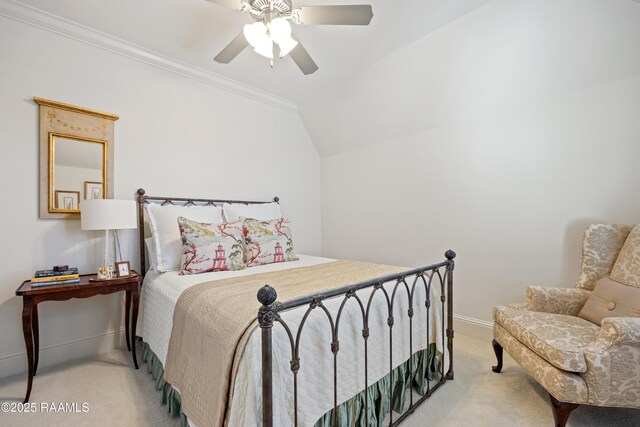 bedroom with a ceiling fan, light carpet, vaulted ceiling, and baseboards