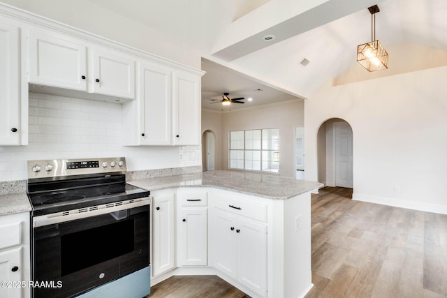 kitchen featuring arched walkways, lofted ceiling, white cabinets, stainless steel range with electric stovetop, and a peninsula