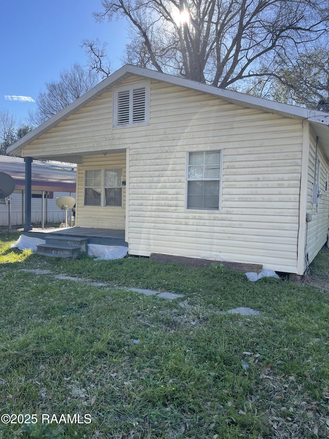 back of property featuring a yard and fence