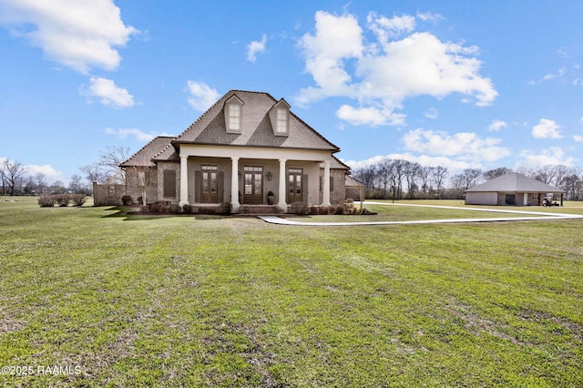 view of front of home with covered porch, a front lawn, and stucco siding