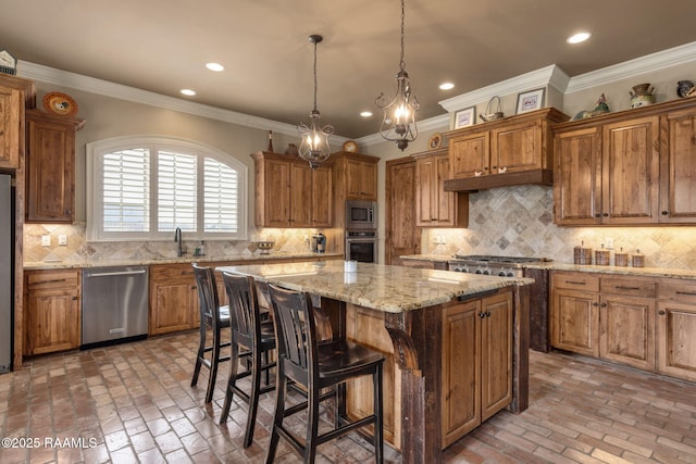 kitchen featuring appliances with stainless steel finishes, brick floor, a kitchen island, and a kitchen bar